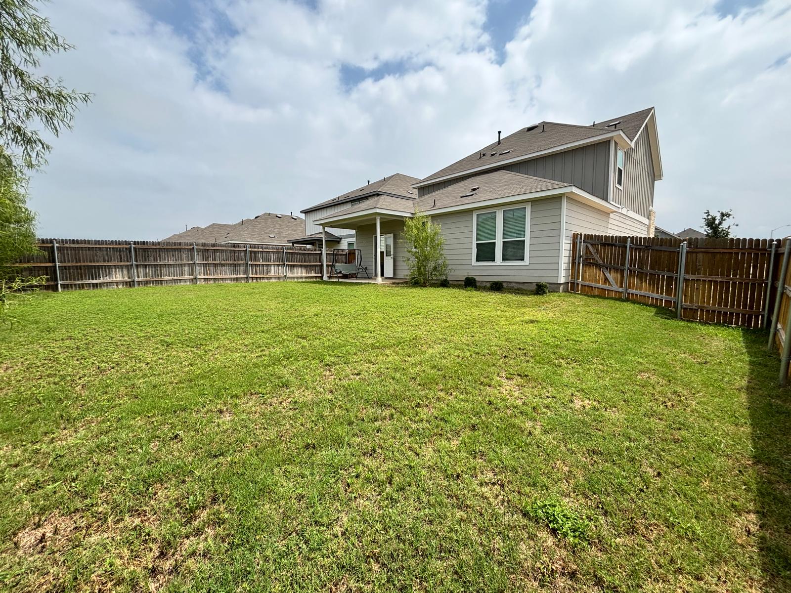 1509 Hope Rnch Road Leander, TX 78641 - Photo 24 of 25 Back of house featuring a shingled roof