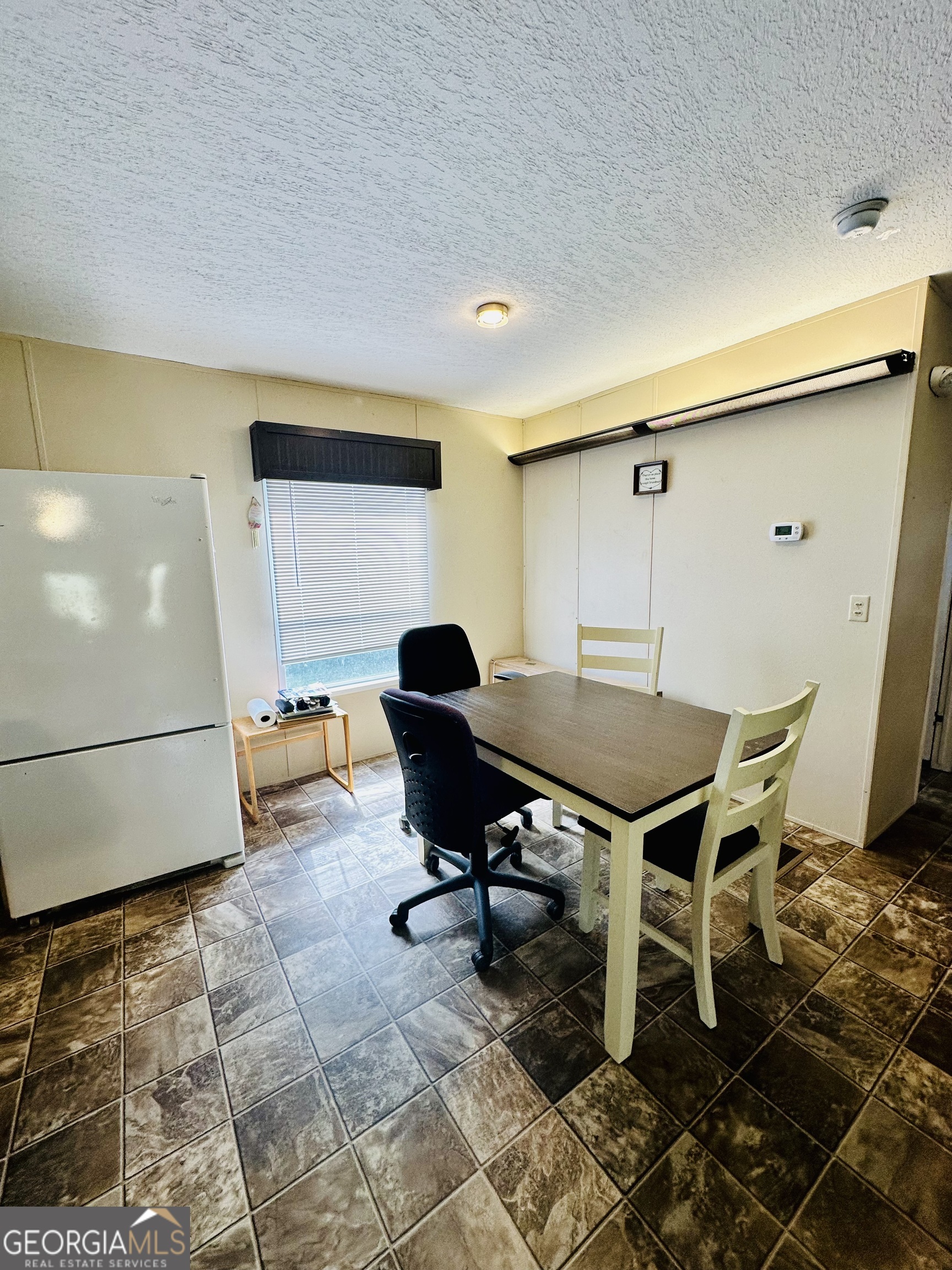 163 Indigo Road Lyons, GA 30436 - Photo 11 of 18 a workspace with furniture and a table