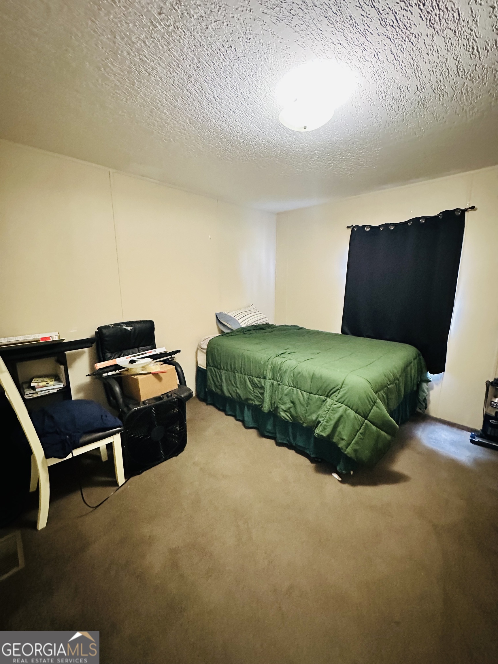 163 Indigo Road Lyons, GA 30436 - Photo 8 of 18 a bedroom with a bed and a chair