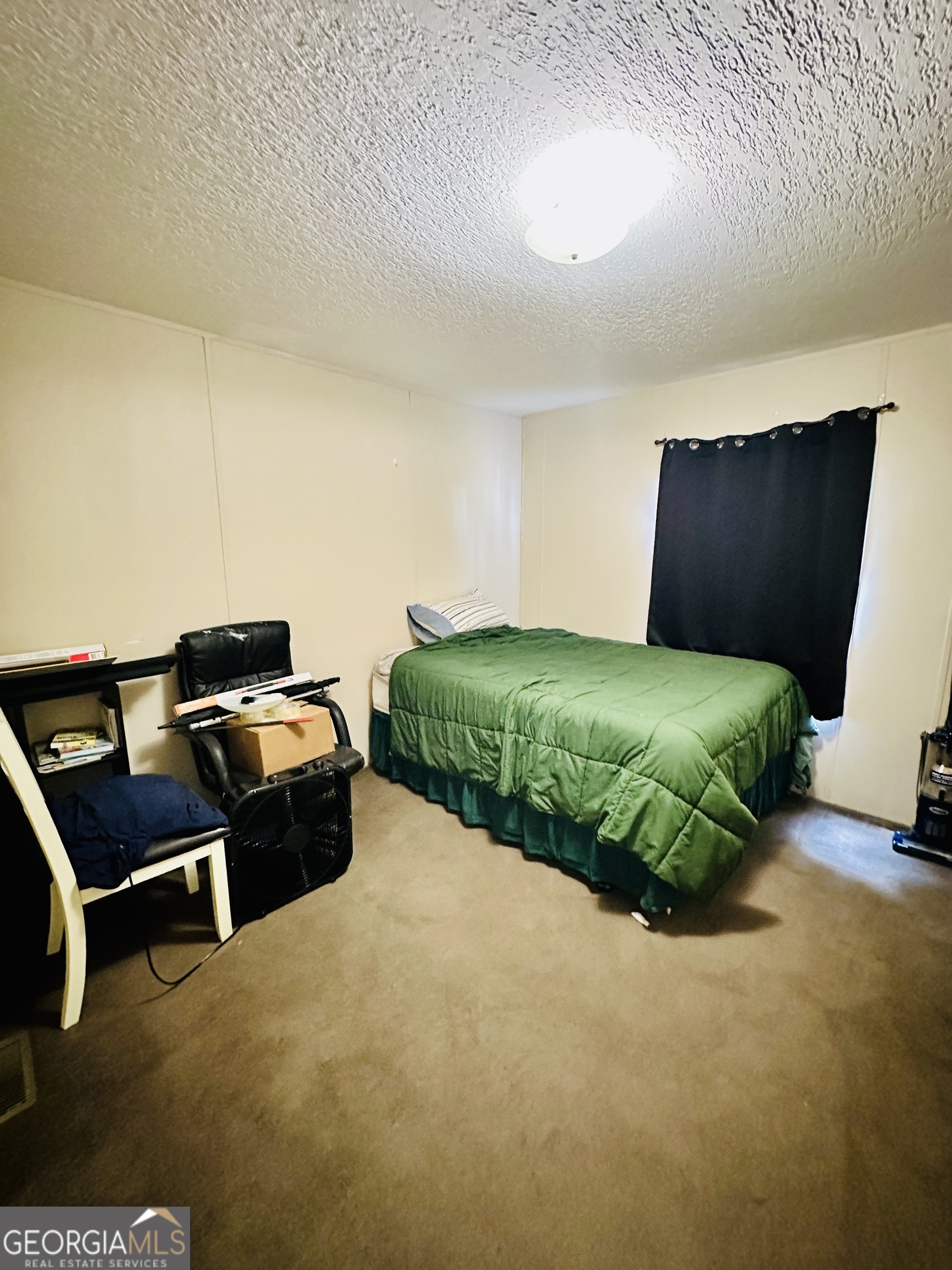 163 Indigo Road Lyons, GA 30436 - Photo 9 of 18 a bedroom with a bed and a chair