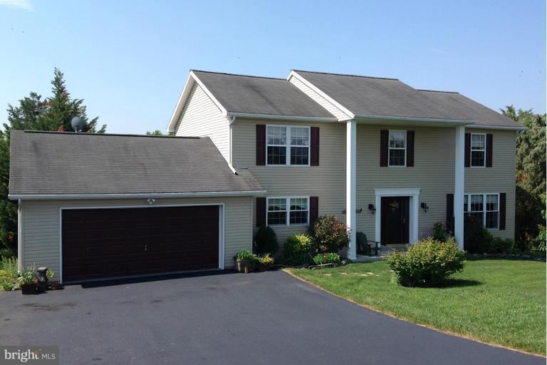 2402 Hoffman Road Greencastle, PA 17225 - Photo 1 of 22 a front view of a house with a garden and garage