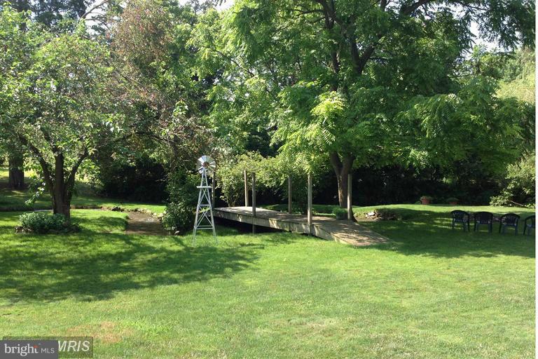 2402 Hoffman Road Greencastle, PA 17225 - Photo 20 of 22 a view of a backyard with wooden fence and a slide