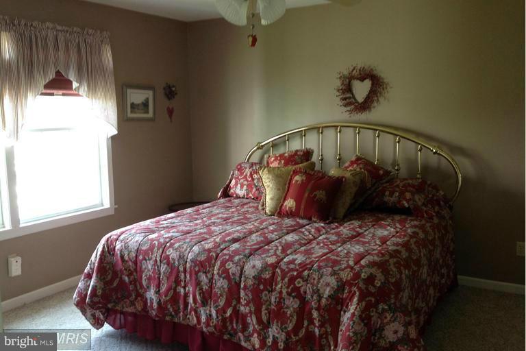 2402 Hoffman Road Greencastle, PA 17225 - Photo 9 of 22 a bed sitting in a bedroom next to a window