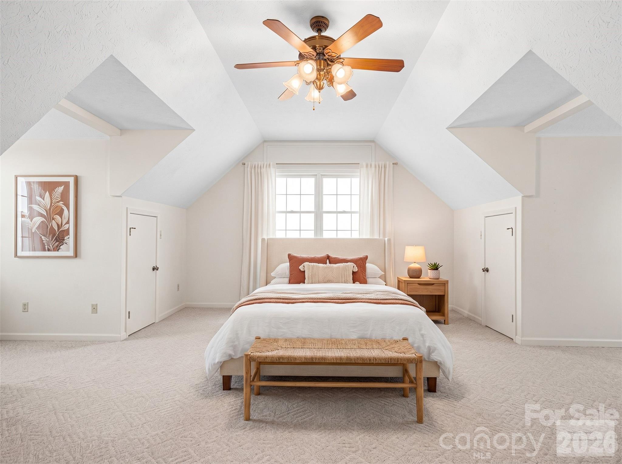 727 Jenkins Valley Road Alexander, NC 28701 - Photo 27 of 48 a bedroom with a bed and a chandelier