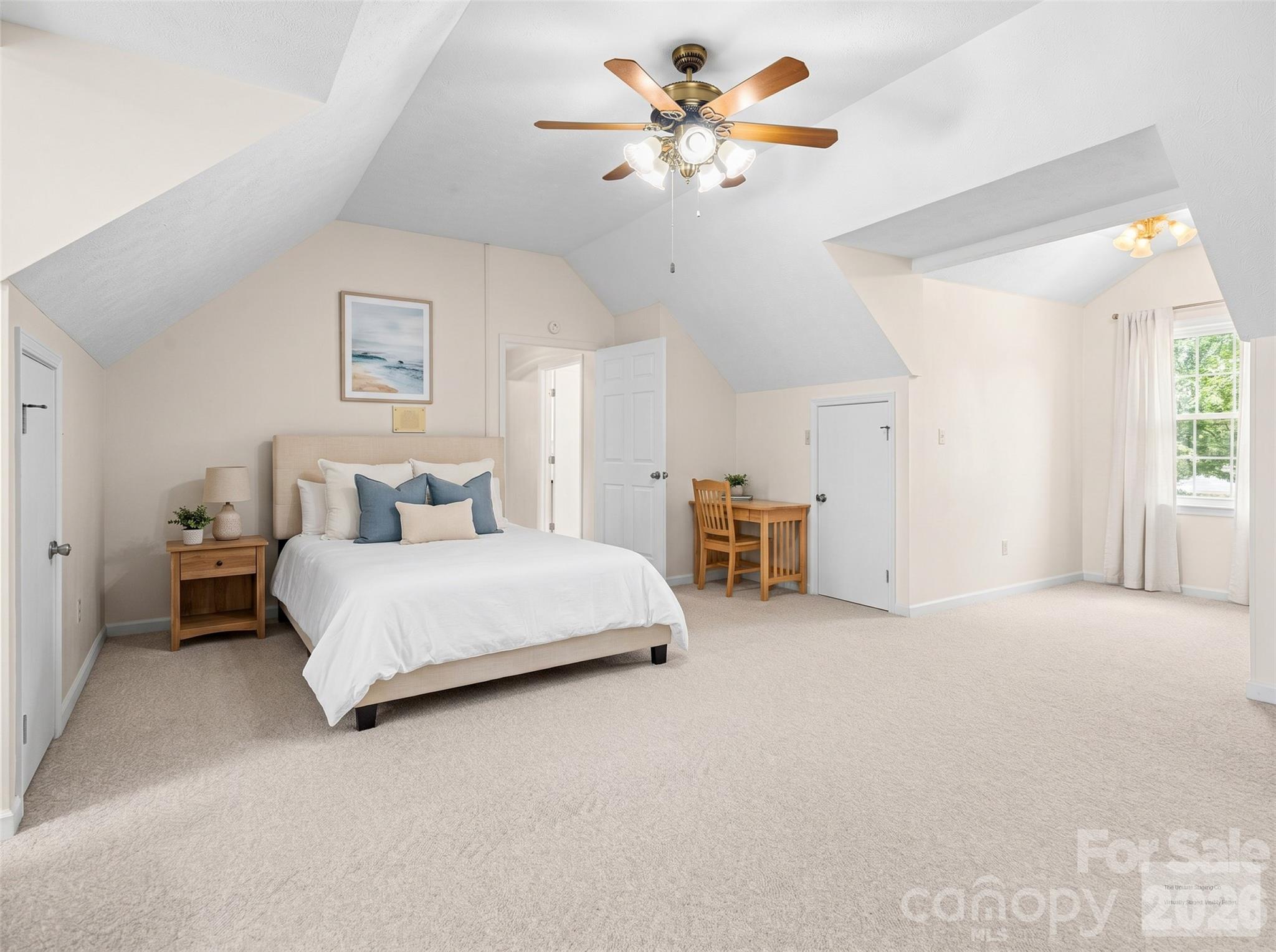 727 Jenkins Valley Road Alexander, NC 28701 - Photo 29 of 48 a spacious bedroom with a bed and a chandelier