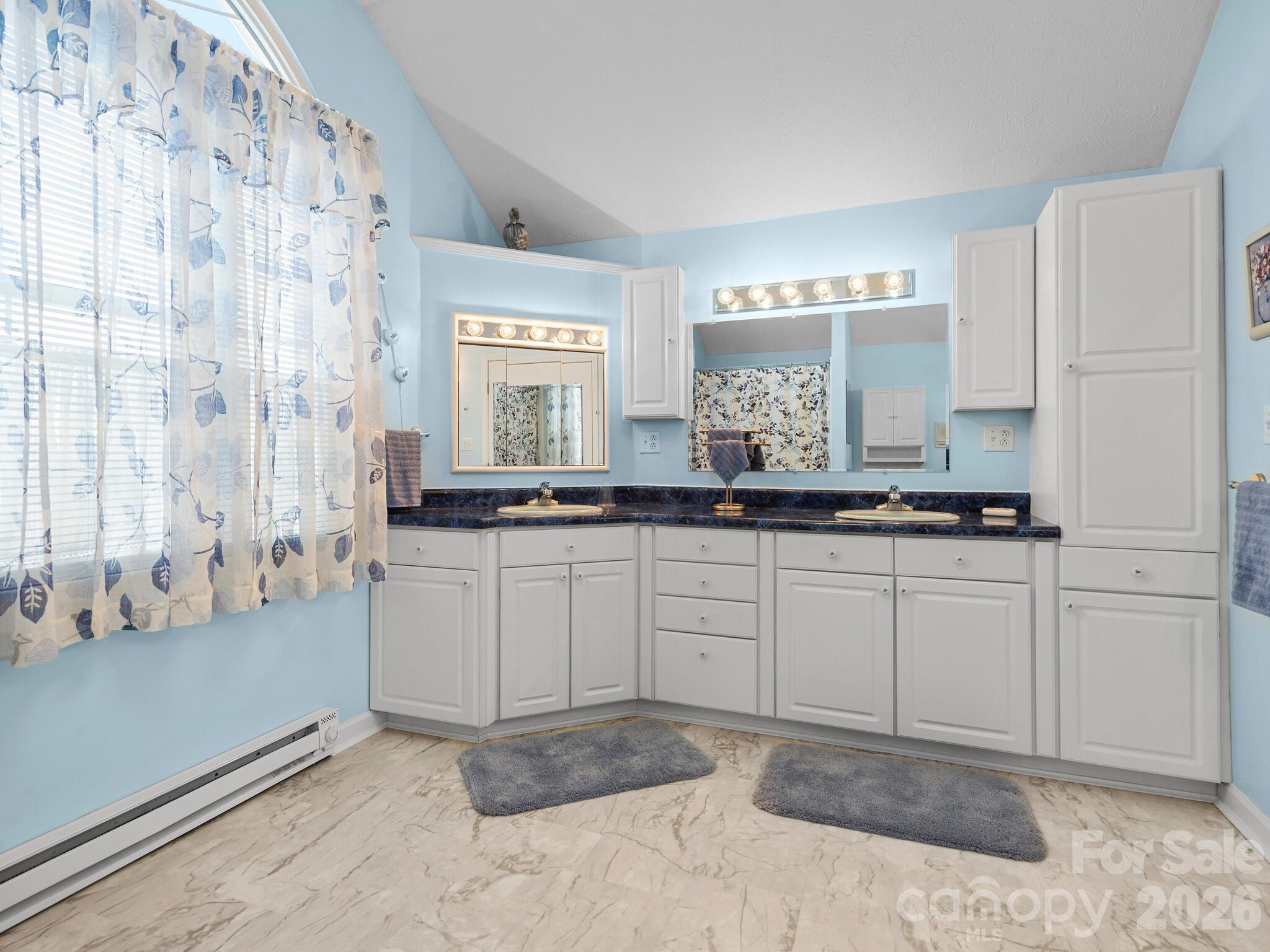 727 Jenkins Valley Road Alexander, NC 28701 - Photo 32 of 48 a spacious bathroom with a granite countertop sink and a mirror