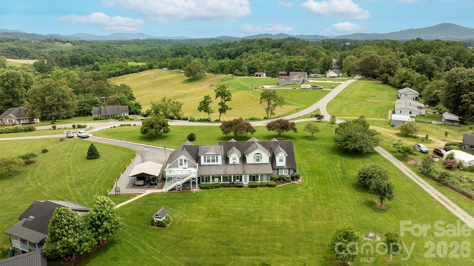 727 Jenkins Valley Road Alexander, NC 28701 - Photo 44 of 48 an aerial view of a house with a swimming pool yard and mountain view in back