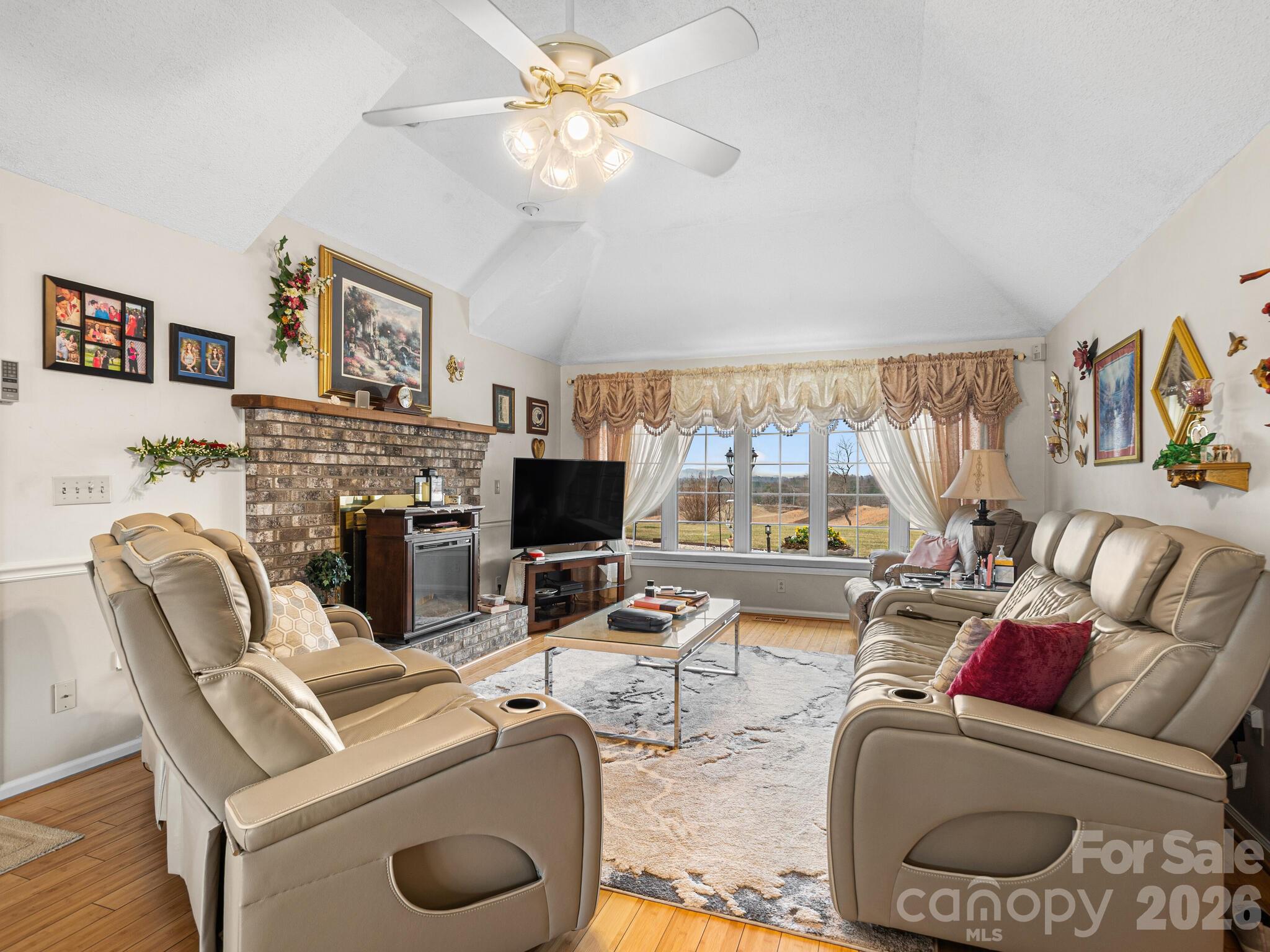 727 Jenkins Valley Road Alexander, NC 28701 - Photo 6 of 48 a living room with furniture a fireplace and a flat screen tv