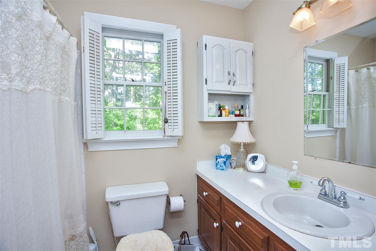 7021 Sandringham Court Raleigh, NC 27613 - Photo 16 of 25 a bathroom with a toilet sink and mirror