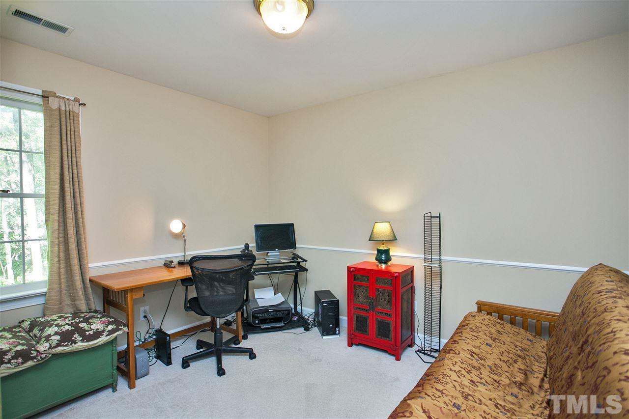 7021 Sandringham Court Raleigh, NC 27613 - Photo 18 of 25 a view of a workspace with furniture and a window
