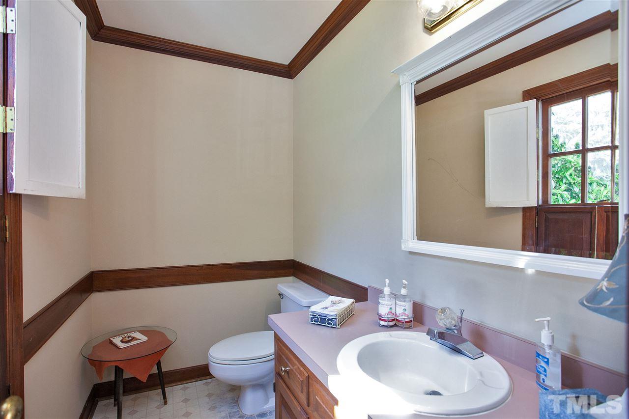 7021 Sandringham Court Raleigh, NC 27613 - Photo 20 of 25 a bathroom with a sink toilet and mirror