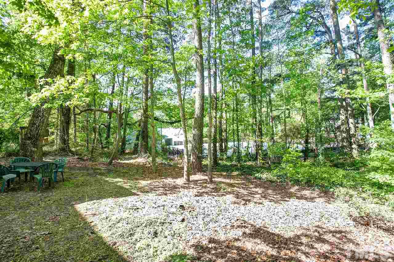 7021 Sandringham Court Raleigh, NC 27613 - Photo 22 of 25 a backyard of a house with lots of green space