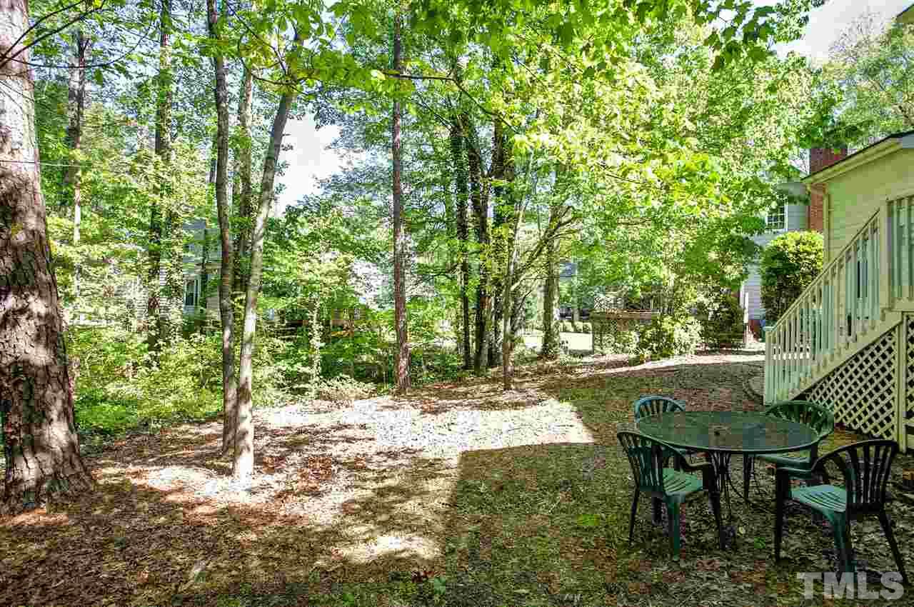 7021 Sandringham Court Raleigh, NC 27613 - Photo 23 of 25 a view of backyard with table and chairs
