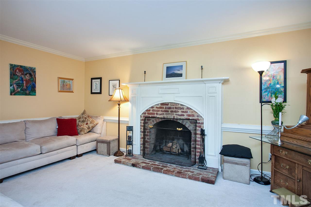 7021 Sandringham Court Raleigh, NC 27613 - Photo 4 of 25 a living room with furniture and a fireplace