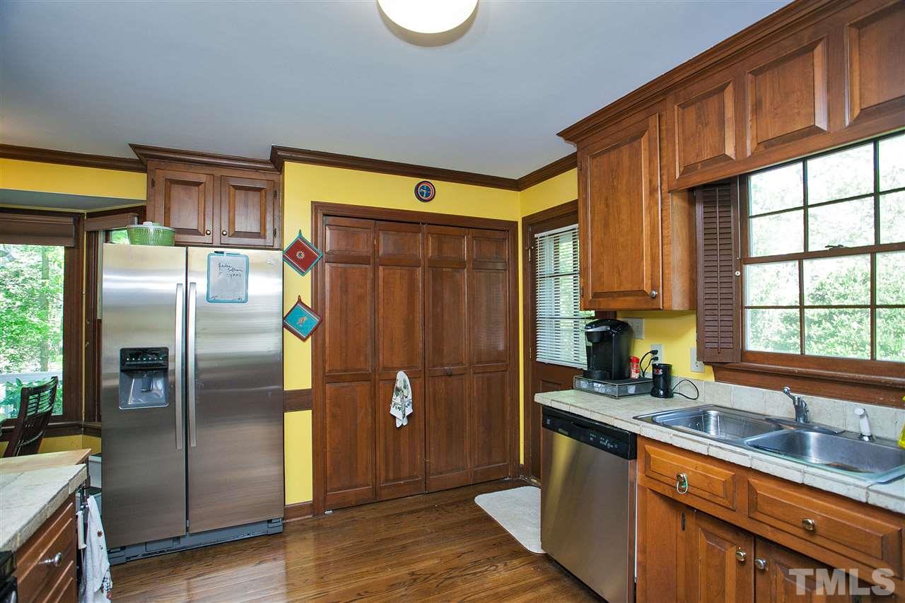7021 Sandringham Court Raleigh, NC 27613 - Photo 9 of 25 a kitchen with stainless steel appliances granite countertop a refrigerator a sink and a large window