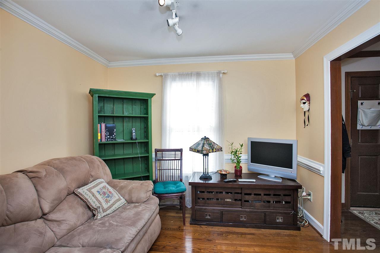 7021 Sandringham Court Raleigh, NC 27613 - Photo 10 of 25 a living room with furniture and a flat screen tv