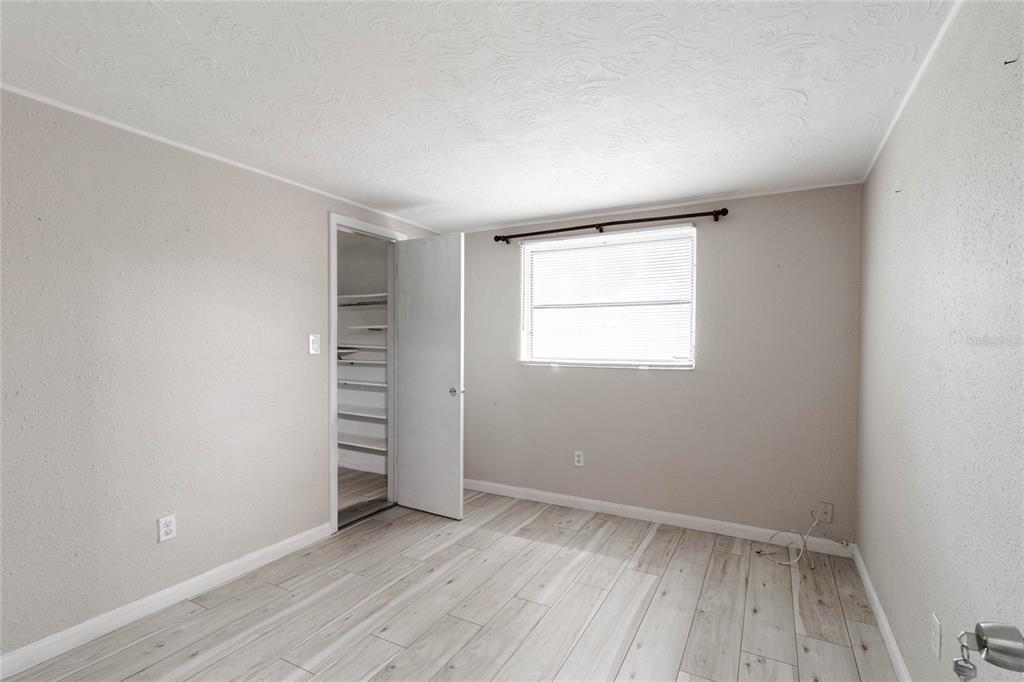 3402 Seffner Drive Holiday, FL 34691 - Photo 14 of 27 an empty room with wooden floor and window
