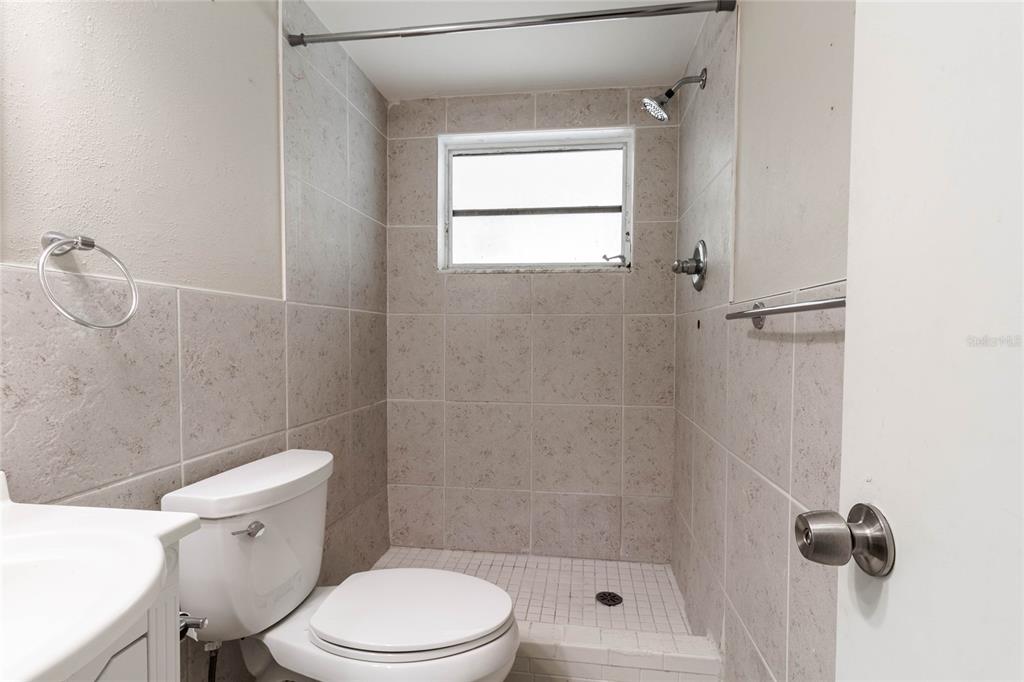 3402 Seffner Drive Holiday, FL 34691 - Photo 18 of 27 a white toilet sitting next to a bathroom sink