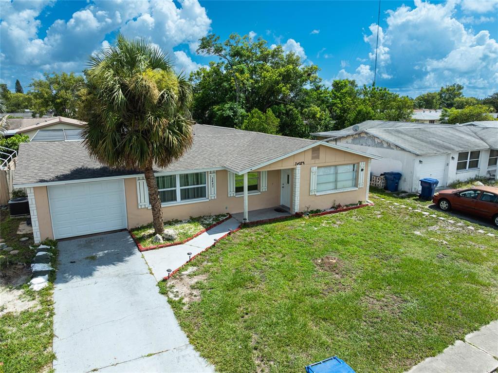 3402 Seffner Drive Holiday, FL 34691 - Photo 2 of 27 a house that has a tree in front of it