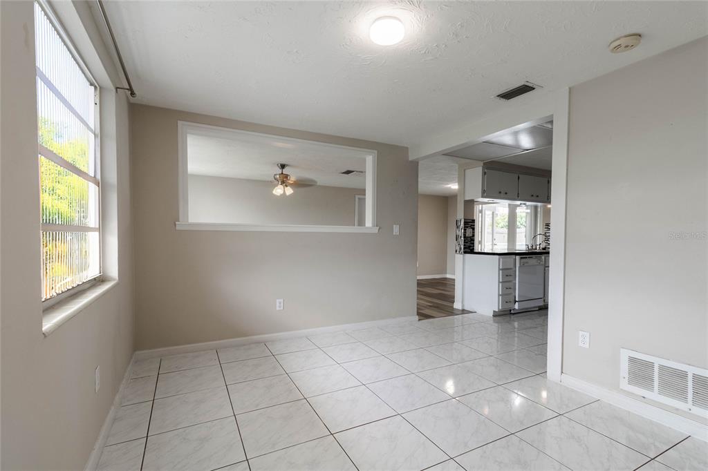 3402 Seffner Drive Holiday, FL 34691 - Photo 7 of 27 a view of empty room with wooden floor and fan