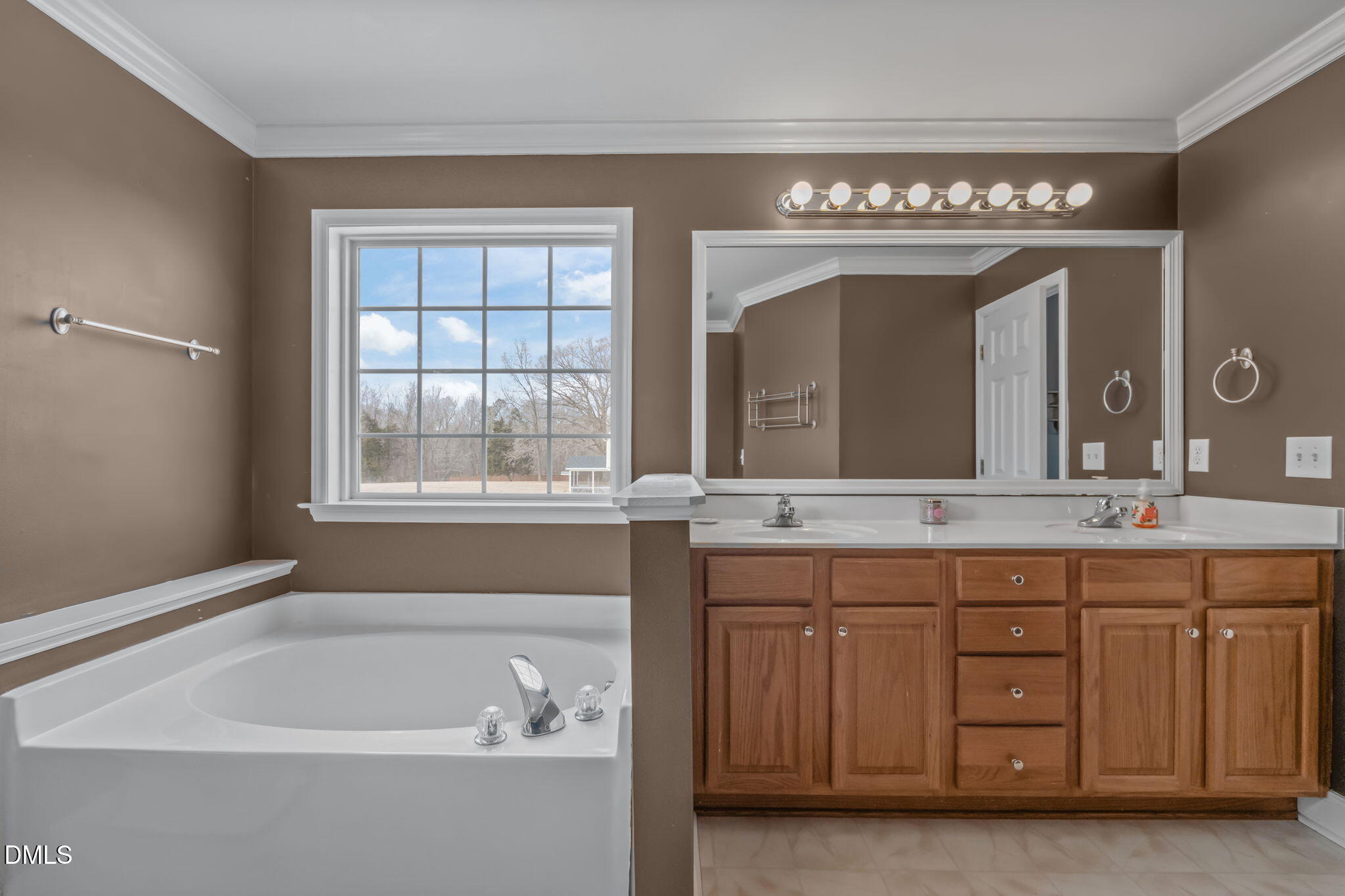 51 Water Front Lane Timberlake, NC 27583 - Photo 18 of 29 a spacious bathroom with a tub a sink and mirror