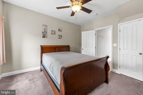 a bathroom with a sink a toilet a mirror and shower curtain
