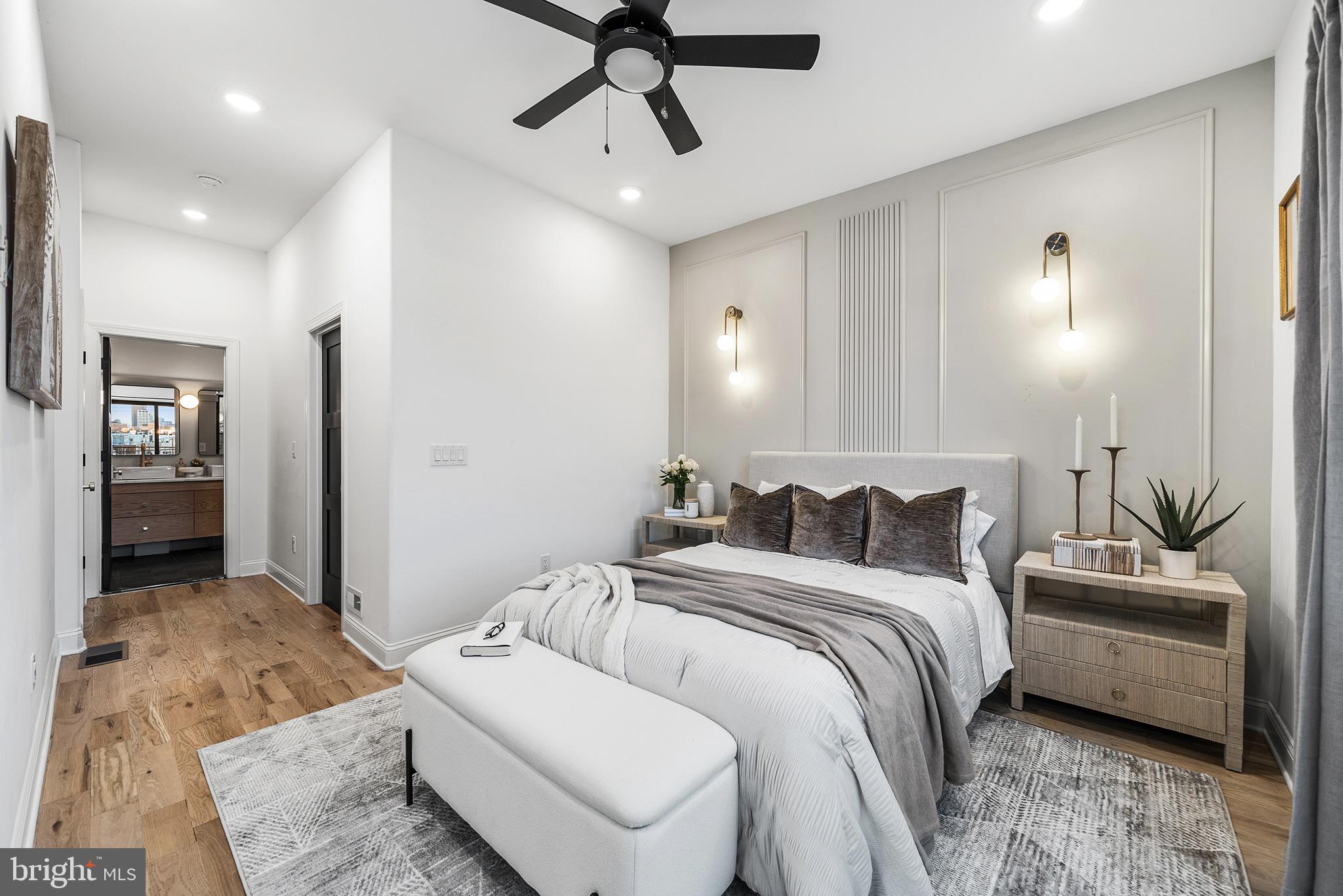 1106 Watkins Street Philadelphia, PA 19148 - Photo 11 of 38 a bedroom with a large bed and a chandelier