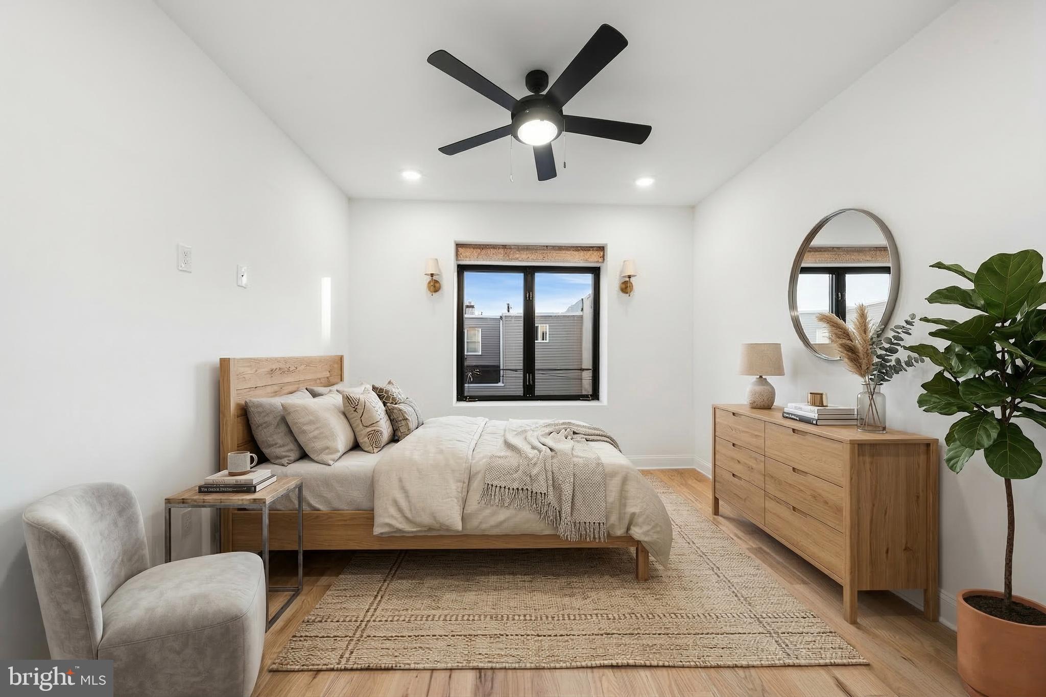 1106 Watkins Street Philadelphia, PA 19148 - Photo 22 of 38 a bedroom with a large bed and a chandelier