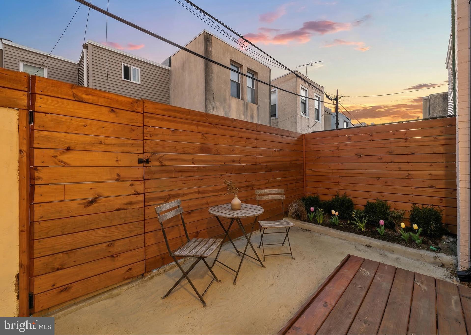 1106 Watkins Street Philadelphia, PA 19148 - Photo 33 of 38 a backyard of a house with table and chairs