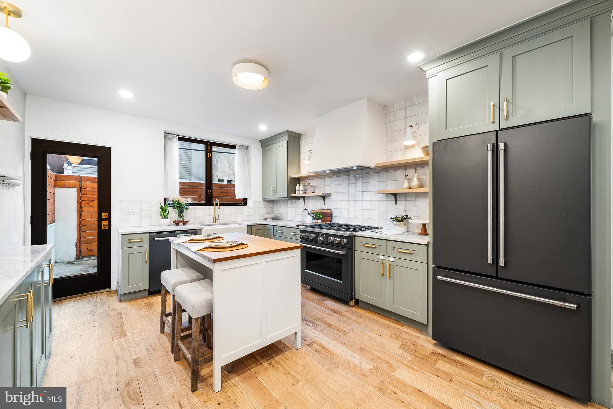 1106 Watkins Street Philadelphia, PA 19148 - Photo 8 of 38 a kitchen with a refrigerator a sink and a stove top oven