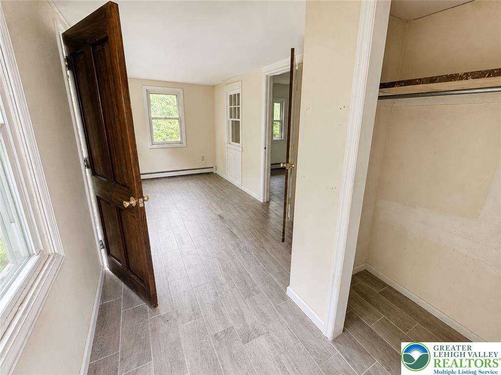 3540 Mountain Road, Unit 3538 Slatington, PA 18080 - Photo 4 of 27 Gleaming wood-look tile floors and classic timber doors define this versatile upstairs room.