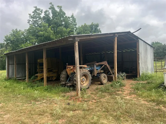 a view of backyard with wooden fence and a car parked