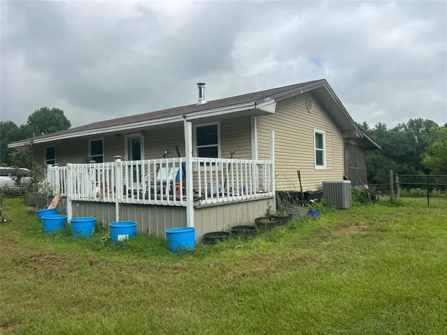 a view of a house with a backyard and deck