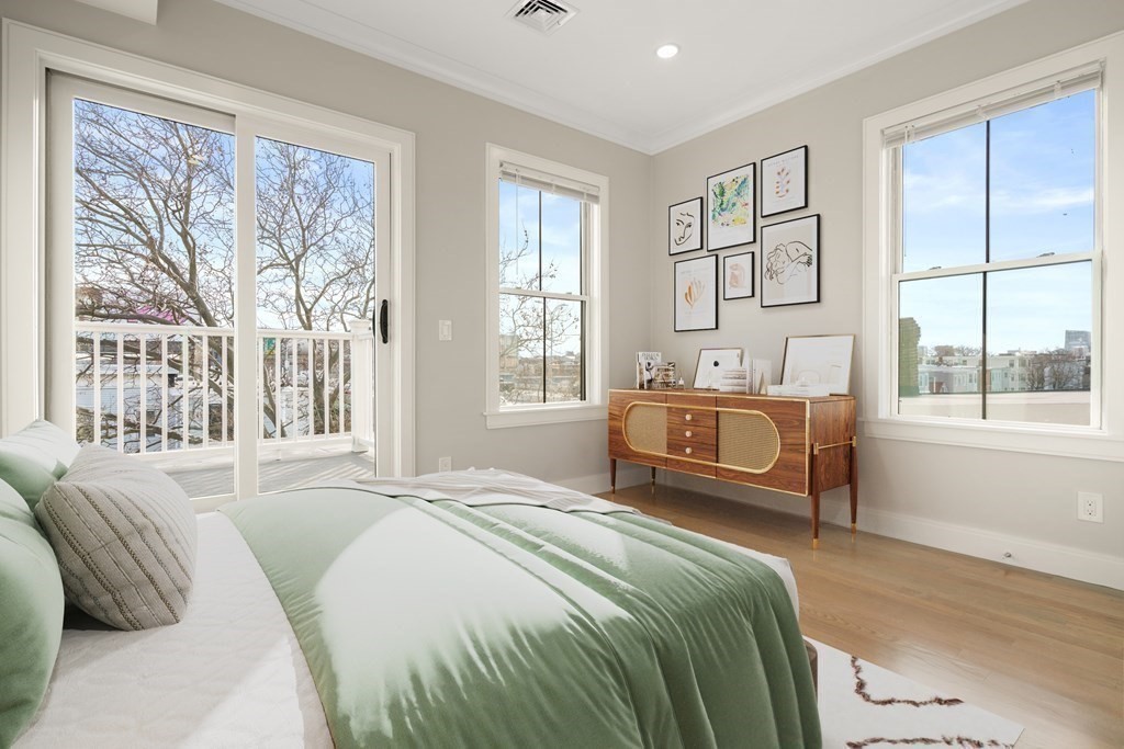 134 Chelsea Street, Unit 1 Boston, MA 02128 - Photo 5 of 13 a bedroom with a bed and a large window