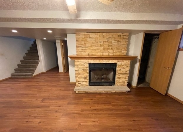 25W271 Foster Avenue Roselle, IL 60172 - Photo 11 of 11 a view of an empty room with wooden floor and a fireplace