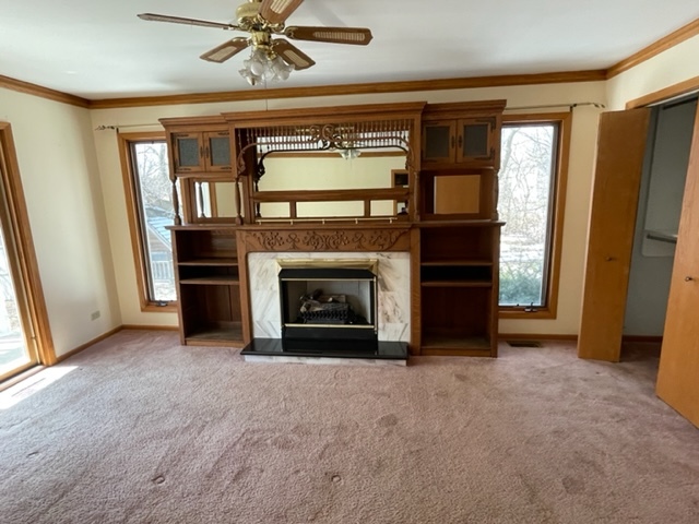 25W271 Foster Avenue Roselle, IL 60172 - Photo 7 of 11 a view of an empty room with a fireplace and a window