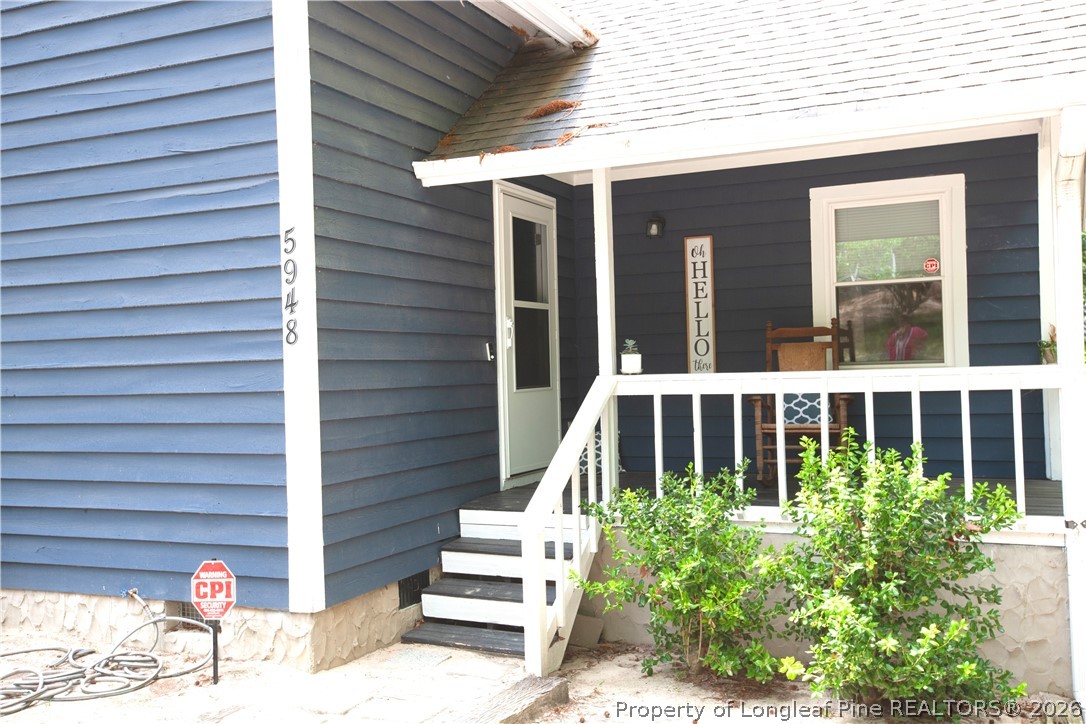5948 Dalton Road Fayetteville, NC 28314 - Photo 5 of 18 a view of a house with a small window and flower plants