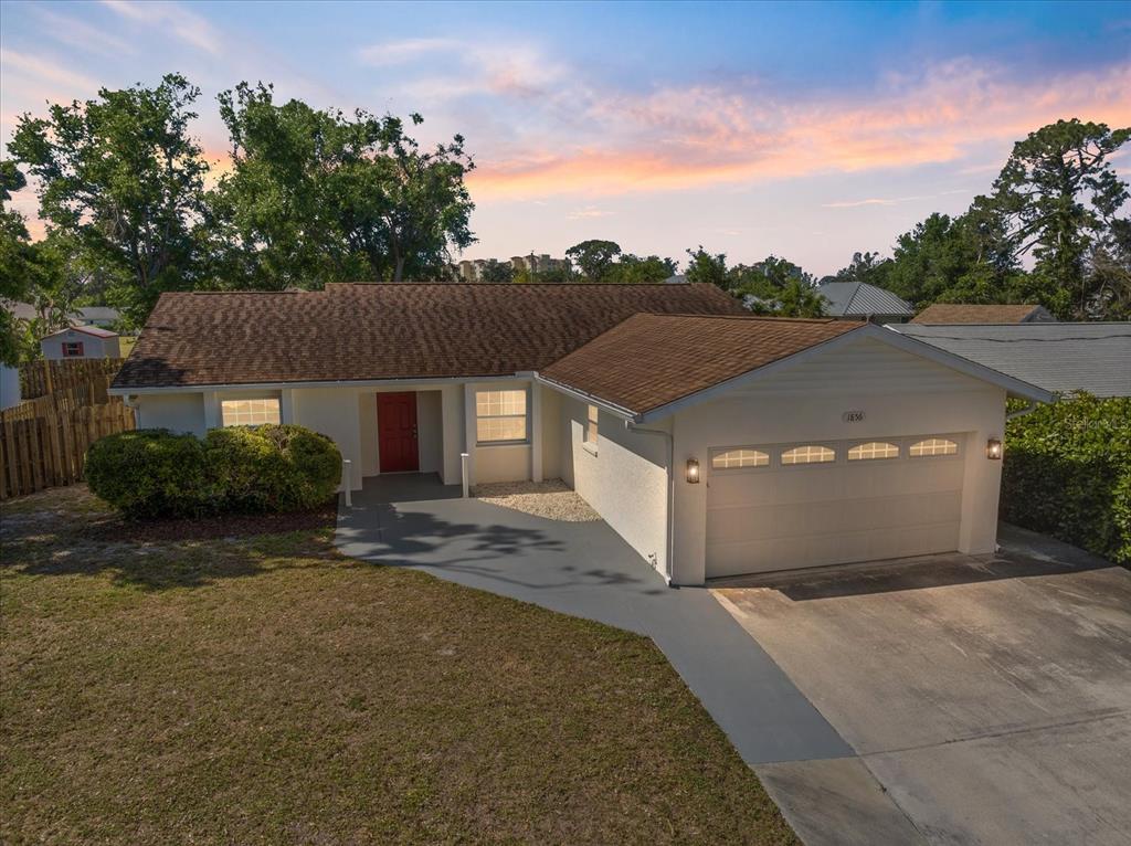 1856 Wharf Road Sarasota, FL 34231 - Photo 1 of 1 a front view of a house with a yard and garage