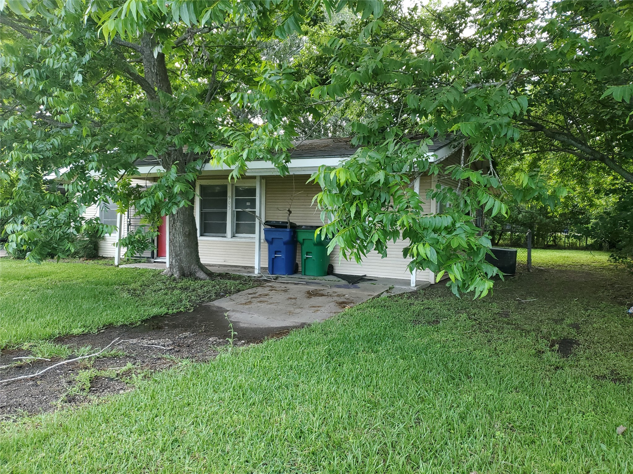 905 East Mulberry Street Angleton, TX 77515 - Photo 3 of 8 a view of a backyard with large trees and plants