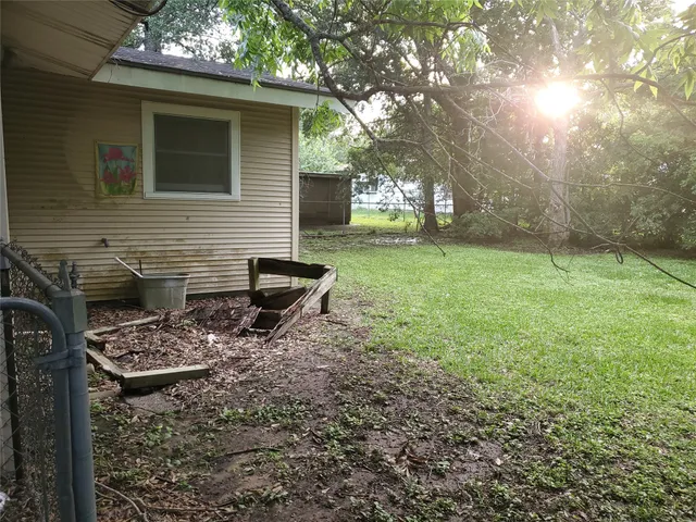 a backyard of a house with table and chairs