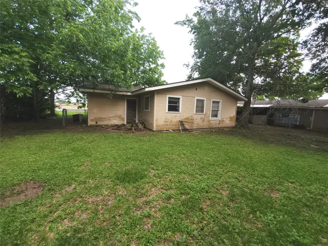 a white house that has a tree in front of it