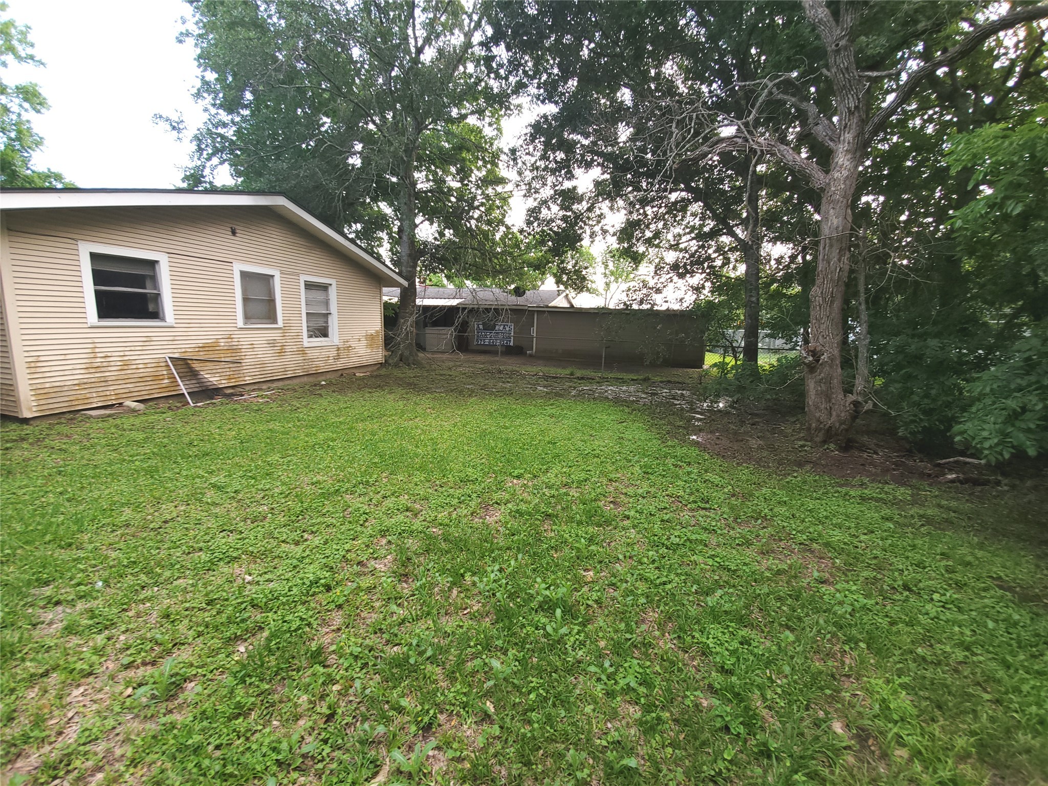 905 East Mulberry Street Angleton, TX 77515 - Photo 7 of 8 a backyard of a house with lots of green space