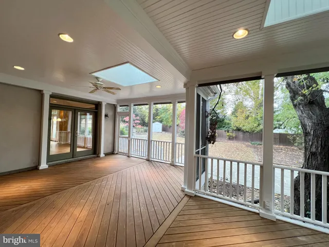 a kitchen with stainless steel appliances granite countertop a refrigerator a stove and a wooden floor