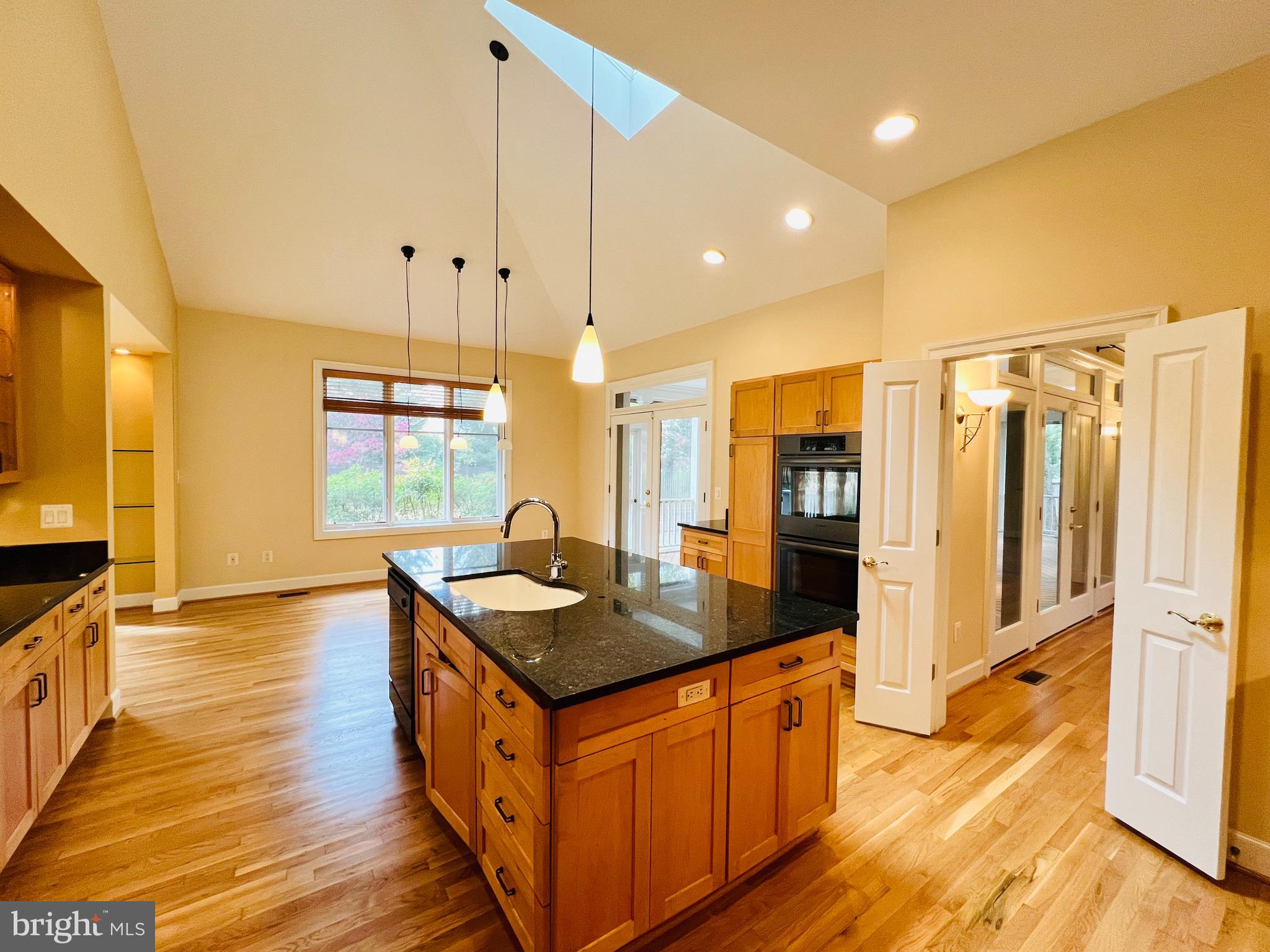 1312 Kurtz Road McLean, VA 22101 - Photo 18 of 62 a kitchen with stainless steel appliances granite countertop a sink a stove and a wooden floors