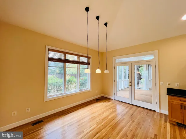 a kitchen with granite countertop white cabinets and refrigerator