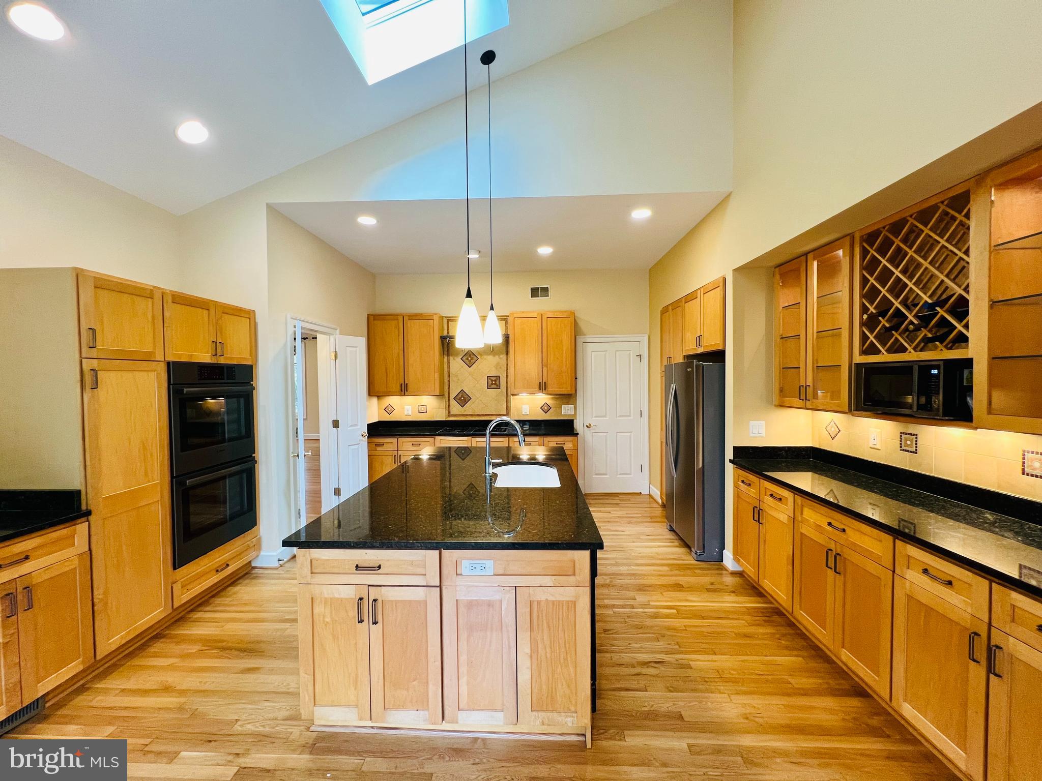 1312 Kurtz Road McLean, VA 22101 - Photo 20 of 62 a large kitchen with stainless steel appliances kitchen island granite countertop a refrigerator and a stove top oven