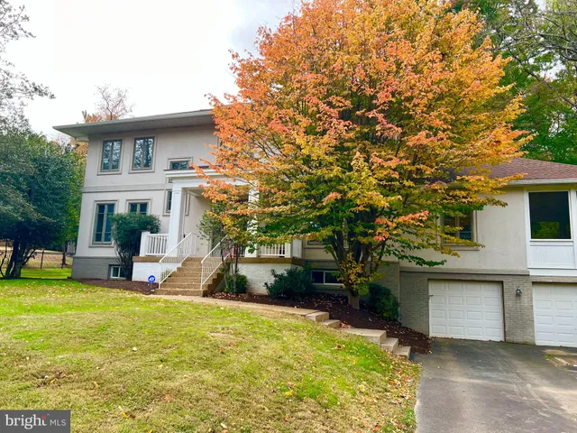 a view of a house with a patio and a yard