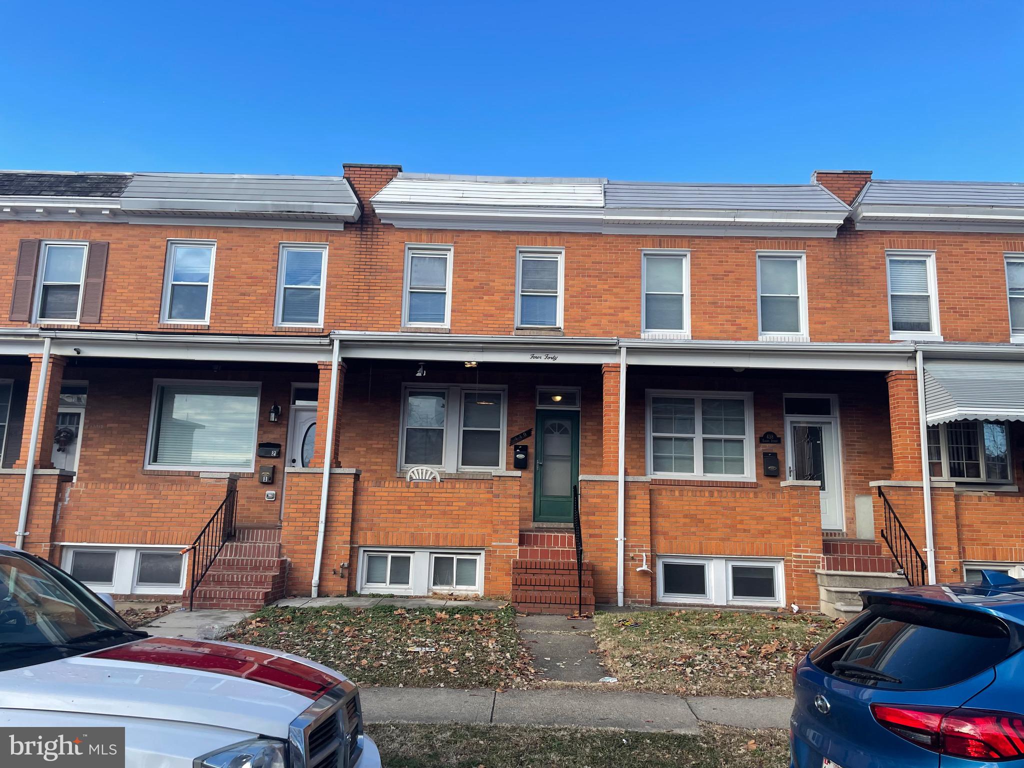 440 Elrino Street, Unit 2 Baltimore, MD 21224 - Photo 1 of 11 a front view of a residential apartment building with a yard