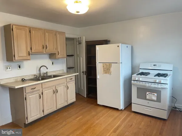 a kitchen with a refrigerator sink and cabinets
