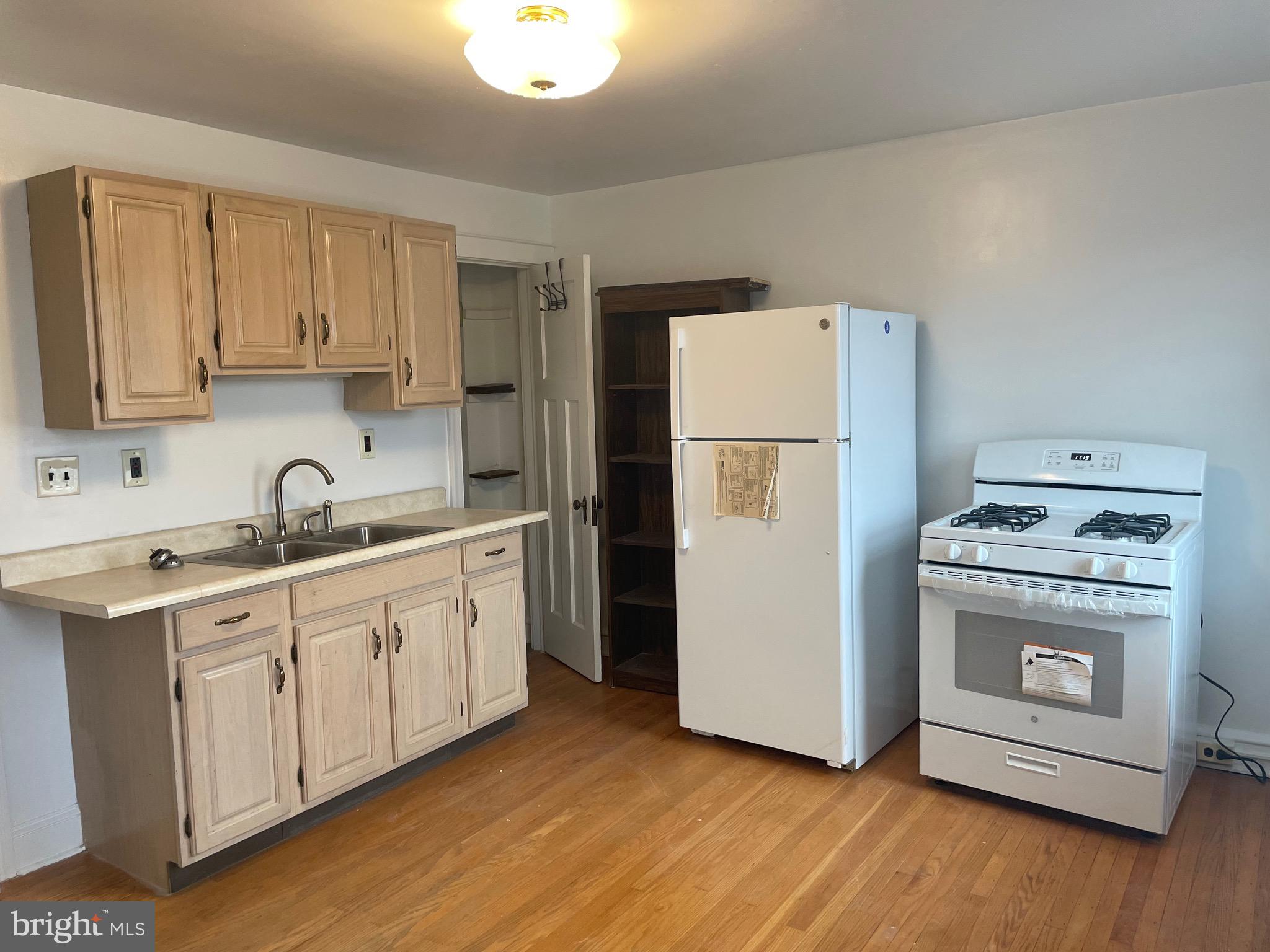 440 Elrino Street, Unit 2 Baltimore, MD 21224 - Photo 5 of 11 a kitchen with a refrigerator sink and cabinets